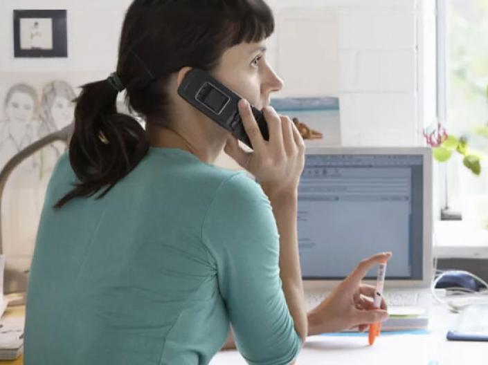 Woman at a desk on a phone